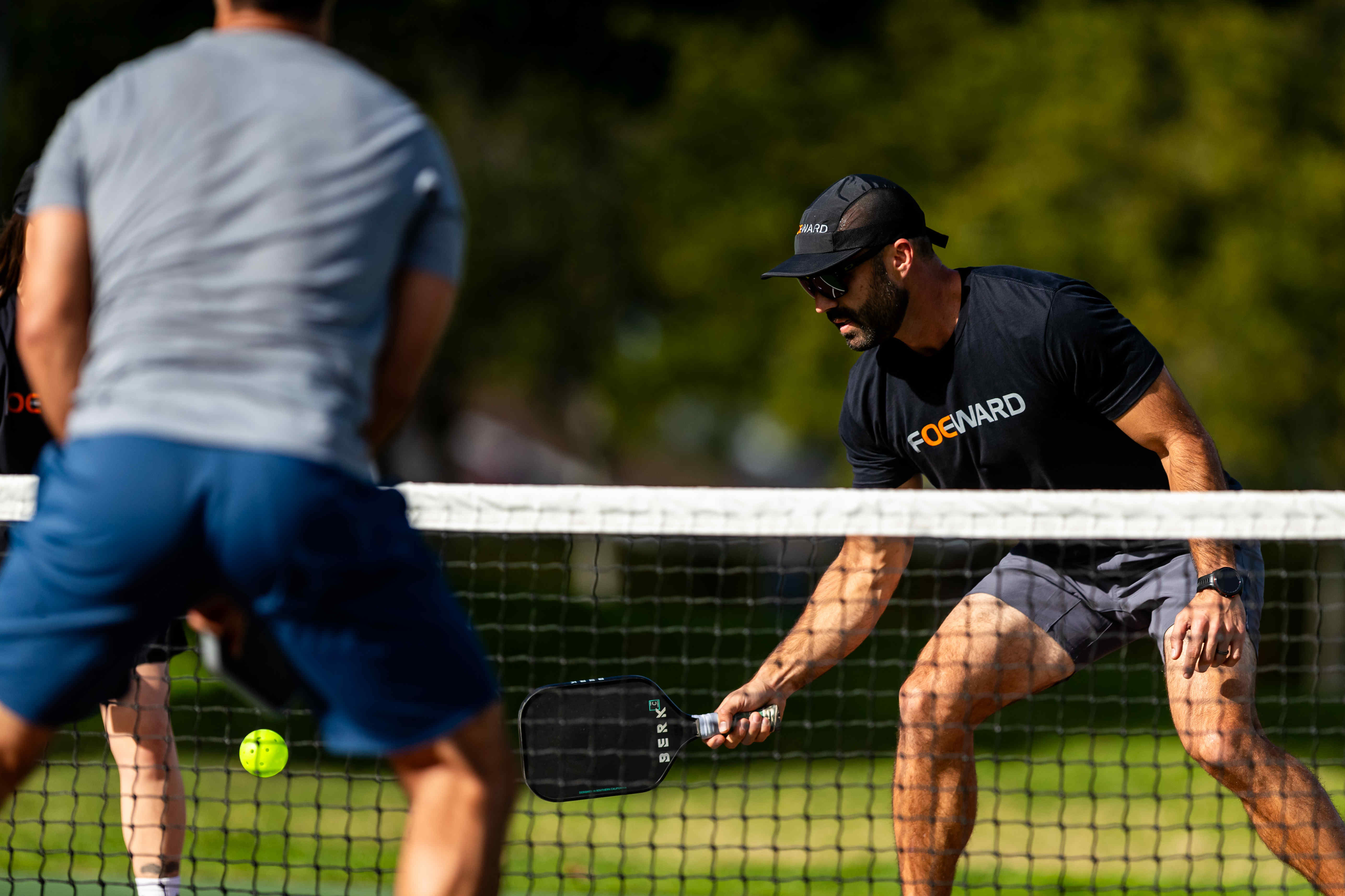two foeward pickleball players playing a game