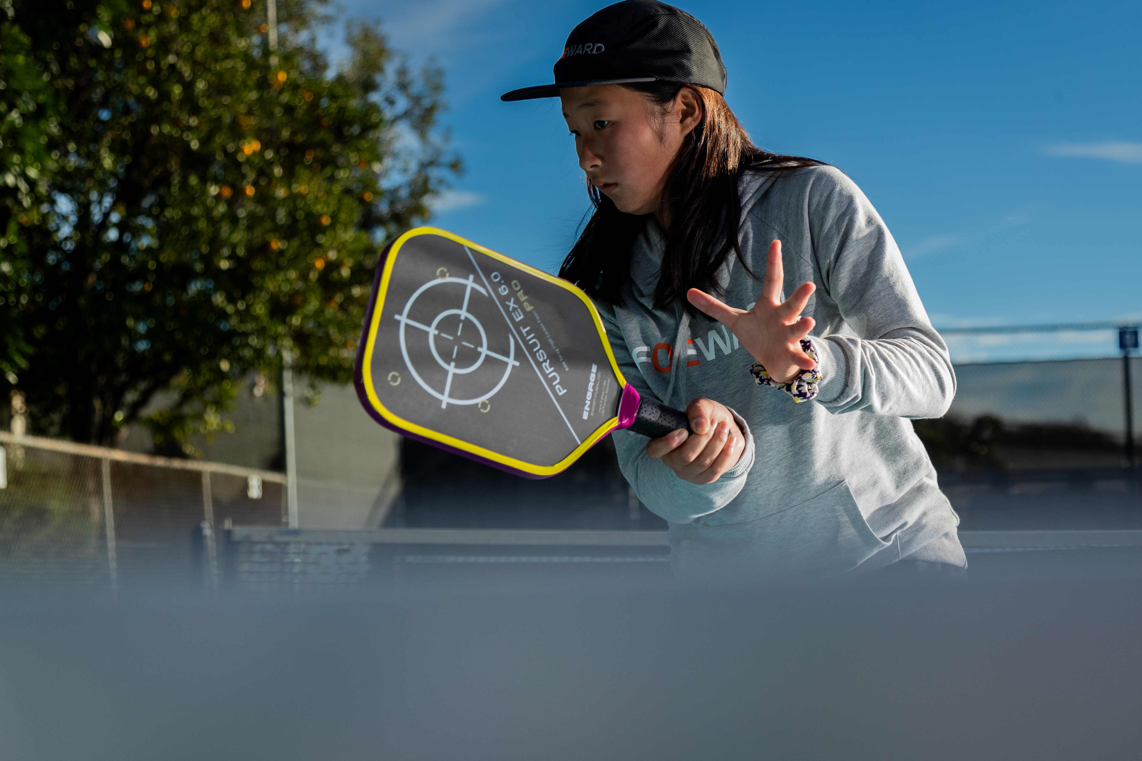 clarissa playing pickleball wearing the foeward pickleball cap